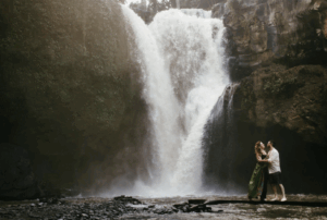 Couple in front of waterfall in Bali